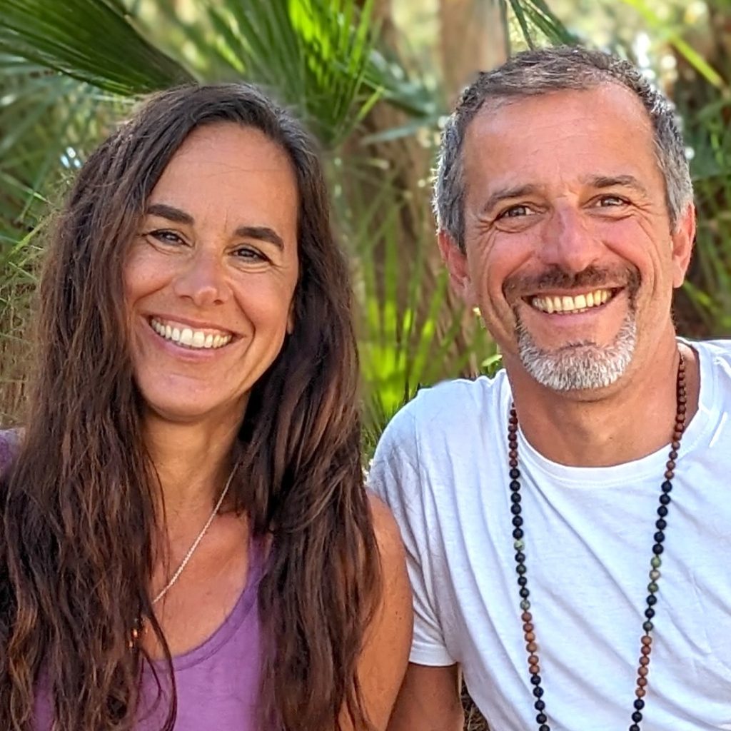 Square picture of Fabio & Julia Giaccone smiling at the Camera with green leaves on the background